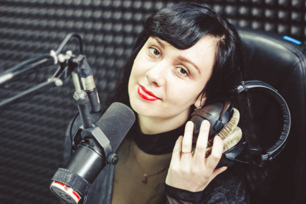 istock the girl at the microphone in the Studio 658093246