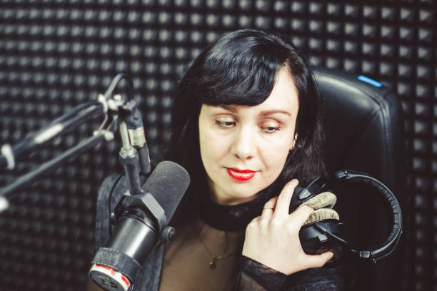 istock the girl at the microphone in the Studio 658093260