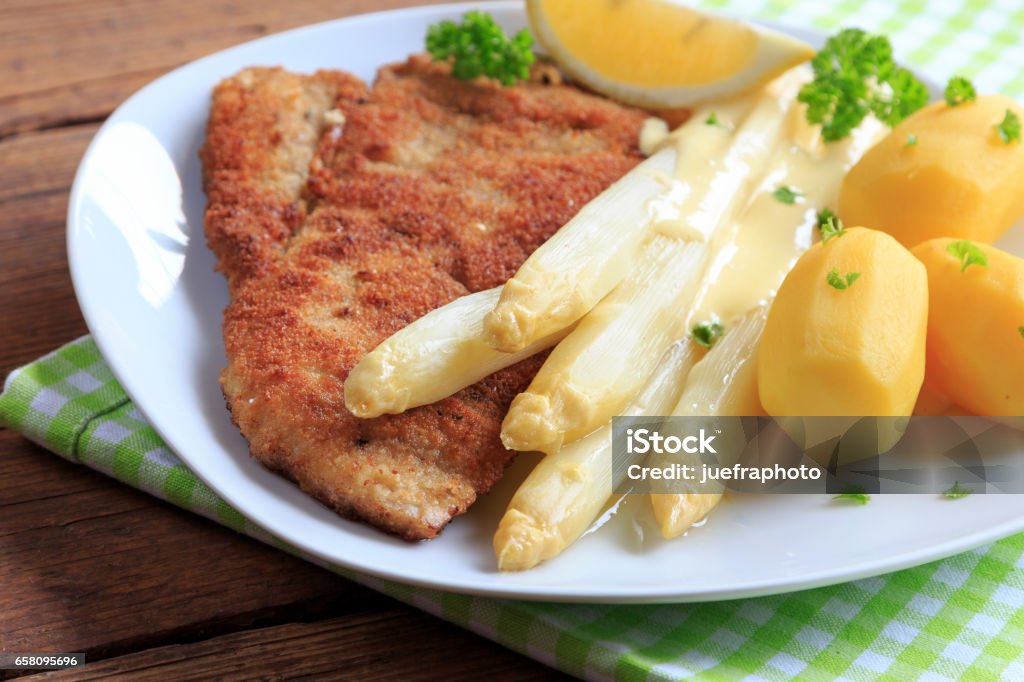 Asparagus with schnitzel and boiled potatoes Asparagus Stock Photo