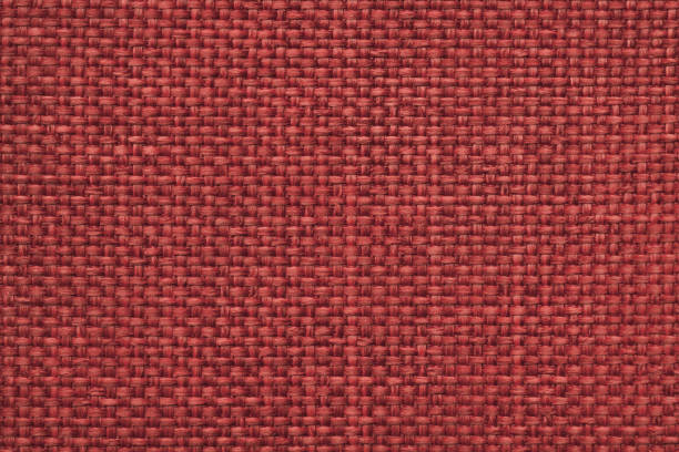 istock Maroon background with braided checkered pattern, closeup. Texture of the weaving fabric, macro. 658096716