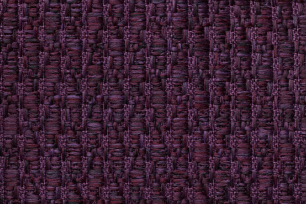 istock Dark purple knitted woolen background with a pattern of soft, fleecy cloth. Texture of textile closeup. 658103522