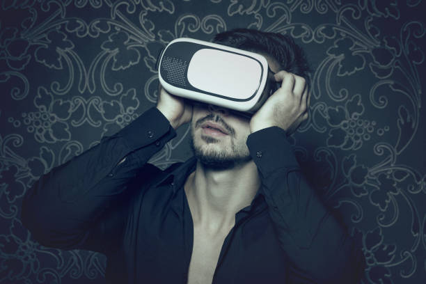 istock Young caucasian man in virtual reality headset enjoying simulation, in cinematic style 658104084