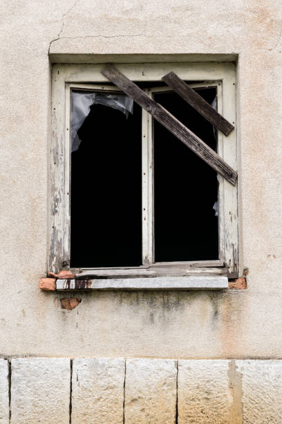 istock old broken window of an abandoned house 658107800