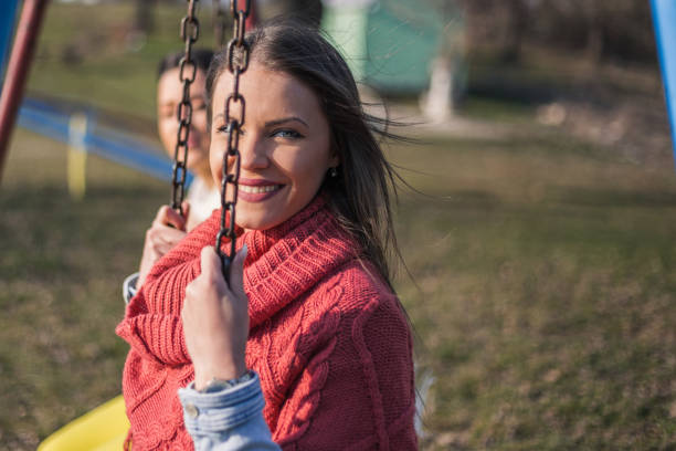 istock Beautiful young woman on swing portrait 658110010