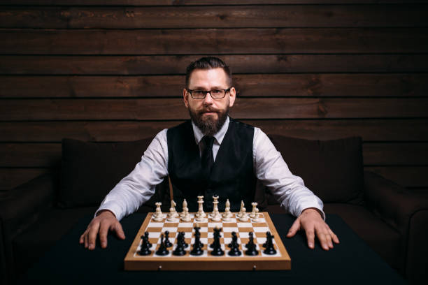 istock Male player against chess board with pieces set 658111492
