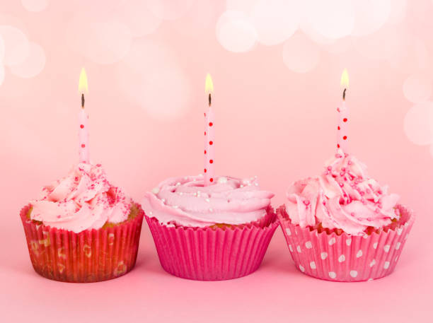 istock Row of three cupcakes with candles 658116072