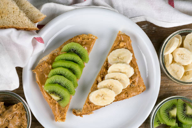 istock Brown bread with peanut butter and fruit 658119436