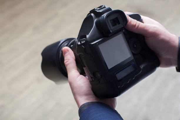 istock Male photographer hands holding digital camera 658123626