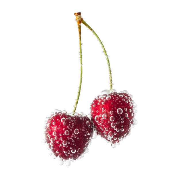 Two cherries covered with air bubbles isolated on a white background stock photo