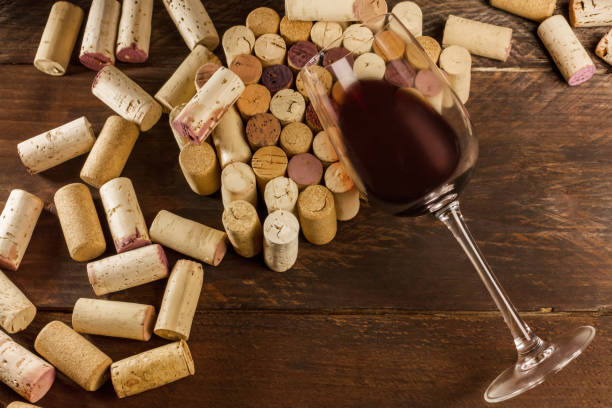 istock Glass of red wine and corks with place for text 658134478