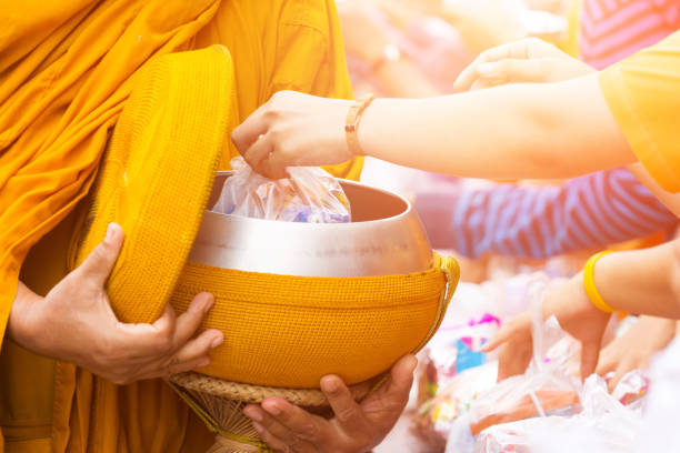 istock offer food to monk 658140644