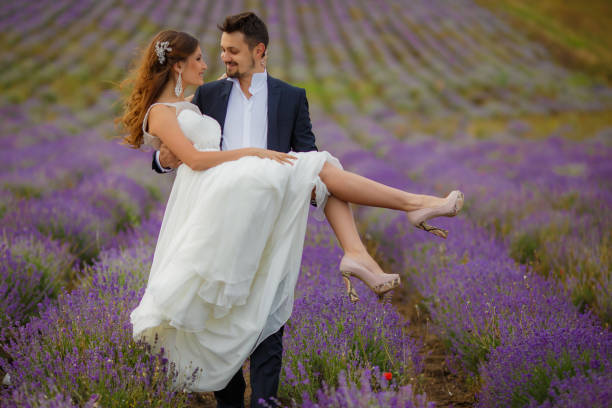 istock The groom carries the bride on hands 658140856