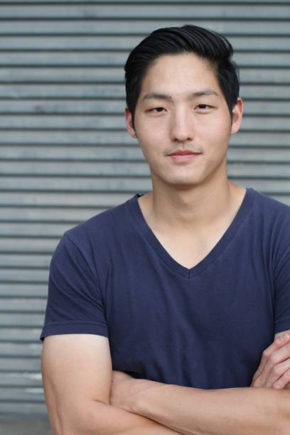istock Asian man smiling with his arms crossed 658141330
