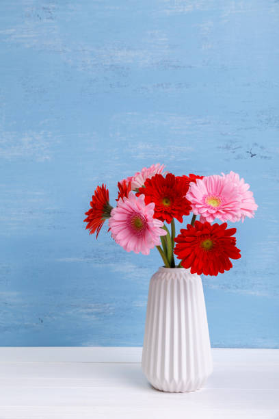 istock Gerbera flowers in vase on wooden background. 658141712