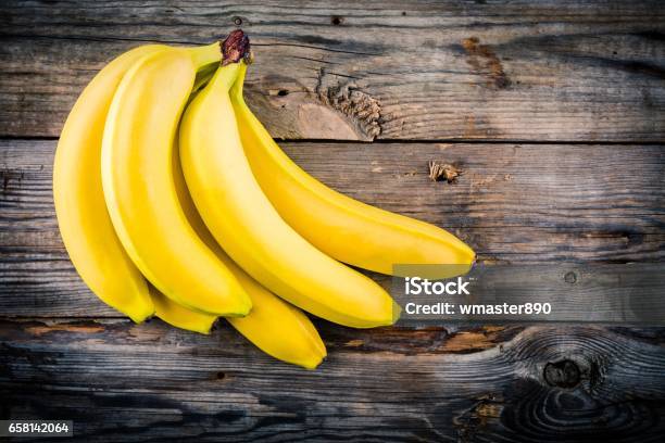 Bunch Of Raw Organic Banana On Wooden Background Stock Photo - Download Image Now - Banana, Above, Peel - Plant Part