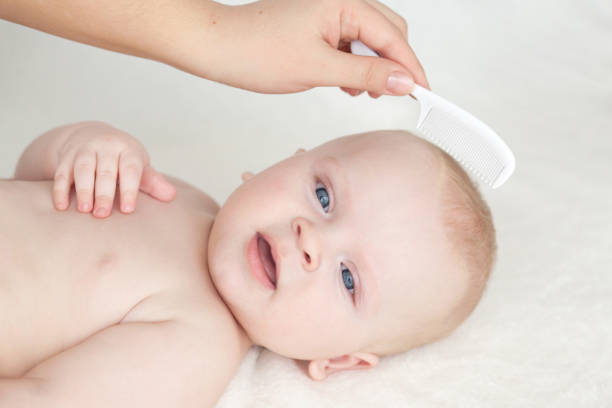istock baby with comb. baby hair 658144836