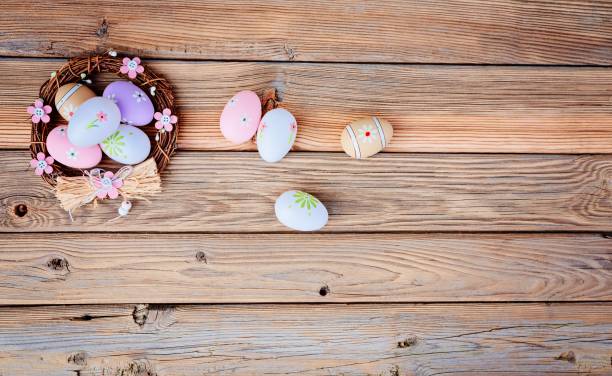 istock Easter eggs in nest on rustic wooden background 658145876