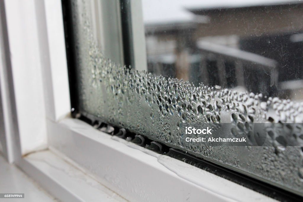 Water condensation on windows during winter Water condensation on windows during winter. Window Stock Photo