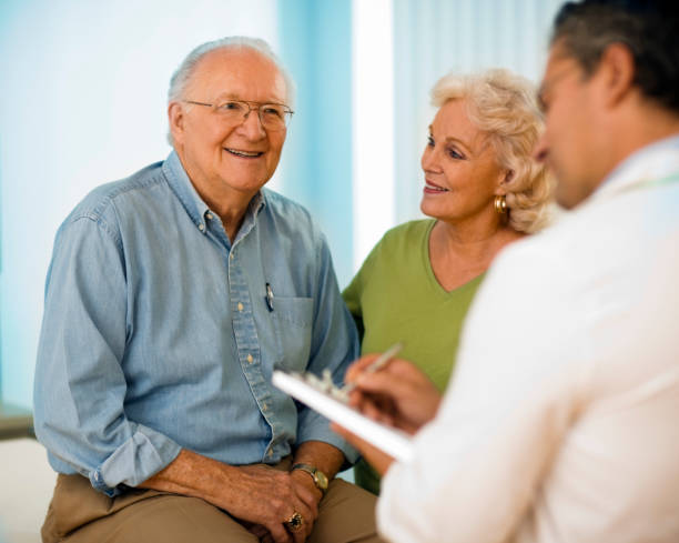 istock Senior couple talking with doctor. 658152148