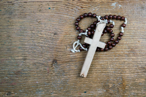 istock Simple Catholic rosary and cross on rustic wood 658160972