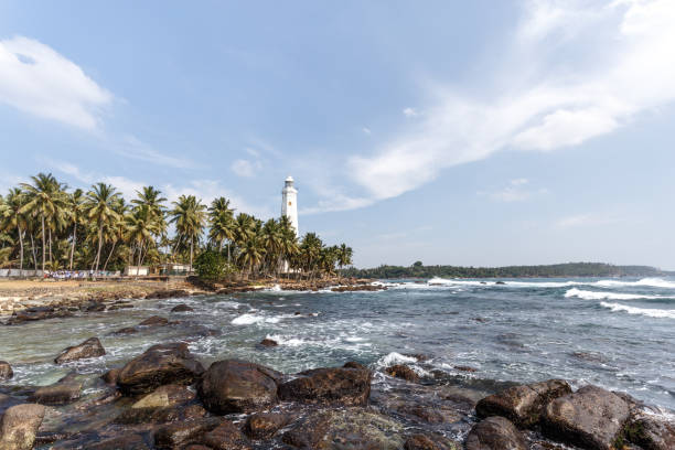 istock Beautiful lighthouse, landscape tropical rocky beach. 658161264