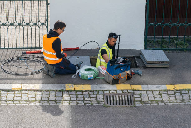 Team of workers working on implementation of fiber optic cables in sewage system Paris: Team of workers from telecomunication internet provider company working on implementation of fiber optic cables in sewage system - aerial view computer plan fiber optic engineer stock pictures, royalty-free photos & images