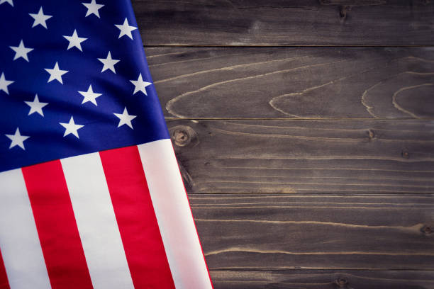 istock USA flag on wooden wall background and texture with space 658174448