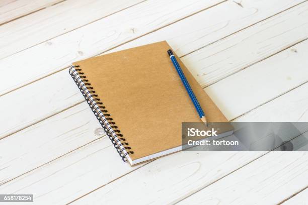 Brown Notebook With Blank Pages And Pencil On Wood Table Stock Photo - Download Image Now