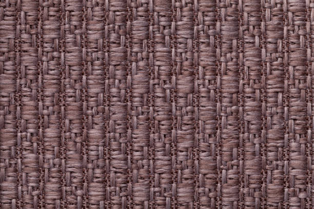 istock Brown knitted woolen background with a pattern of soft, fleecy cloth. Texture of textile closeup. 658178862