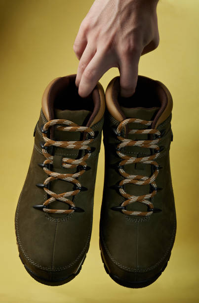 istock Hiking shoes hang on hand 658184348
