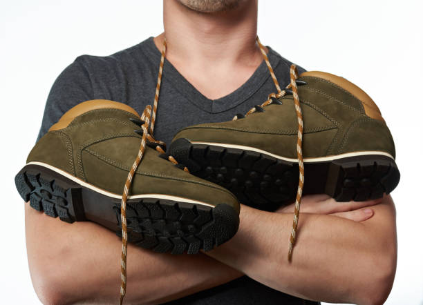 istock Man with hiking shoes on neck 658184462