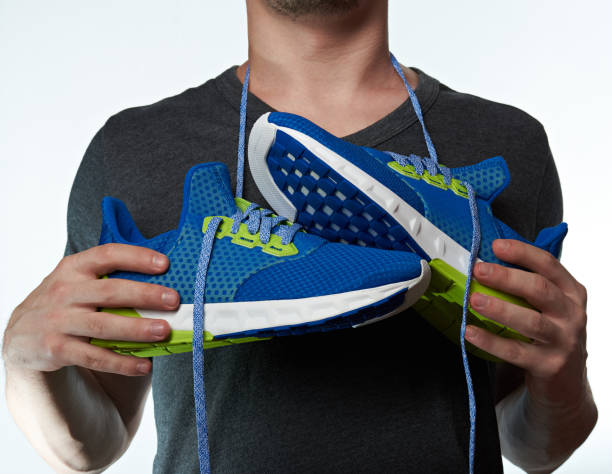 istock Sport shoes hang on man neck 658184482