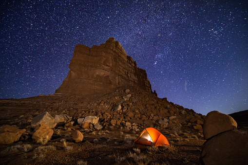 Camping Under the Stars in Canyon Country Utah - Nightime view of camp with stars and Milky Way galaxy.