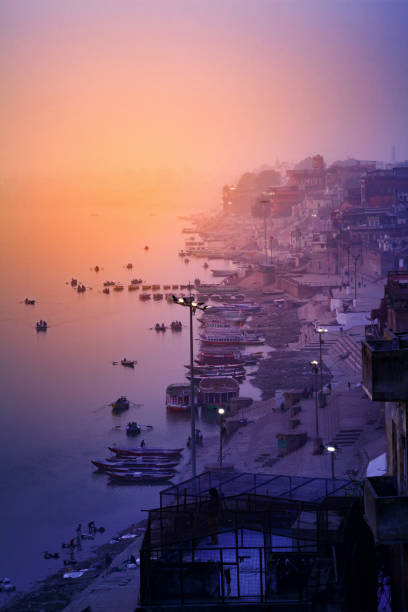 ghats (banks) on the ganges river - morning river ganges river varanasi imagens e fotografias de stock