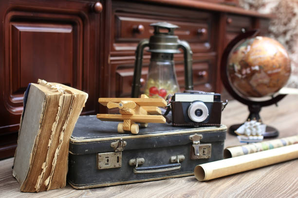 istock composition on a wooden floor vintage globe with old leather sui 658195484
