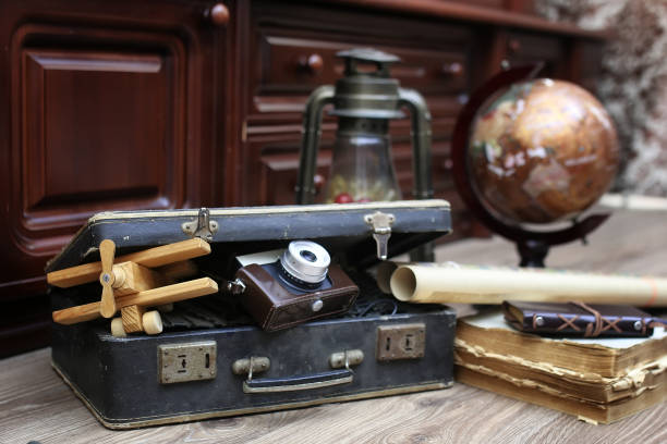 istock composition on a wooden floor vintage globe with old leather sui 658195522
