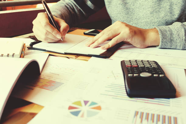 istock Businesswoman writing make note and calculate about debt. 658195990
