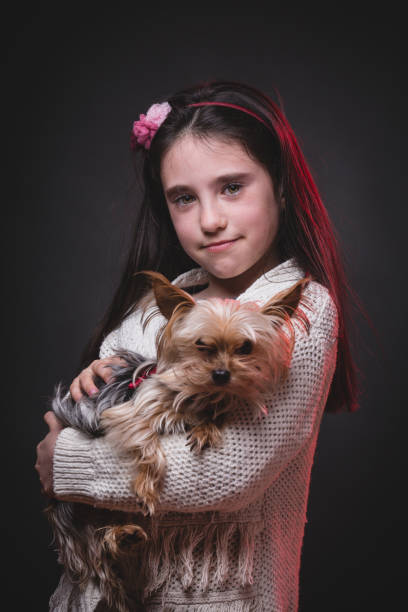 istock Little girl with her sweety yorkshire terrier. 658198366