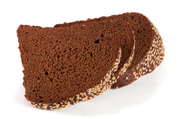 istock Three slices of black bread with sesame seeds isolated on white background 658201462