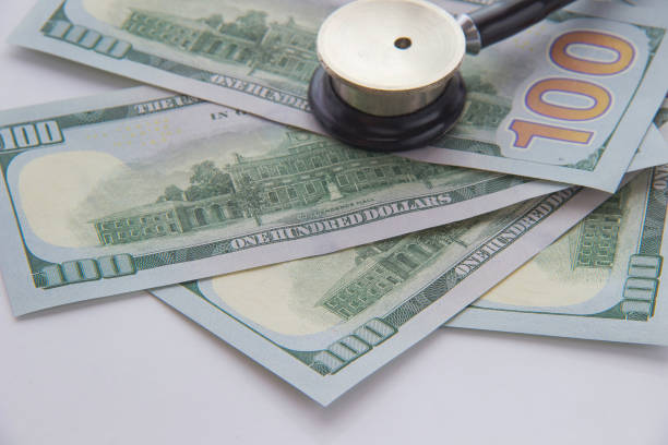 istock Stethoscope and money on a white background. Closeup 658201584