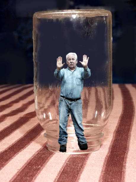 istock Man Trapped Under a Glass Jar in The Giant's House 658212898