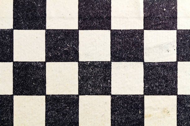 istock Fragment of a paper chess board. Abstract black and white background 658213110