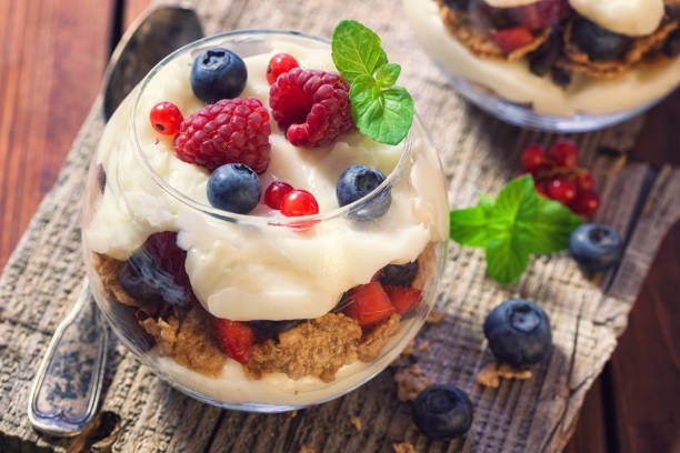 Homemade granola parfait with berry fruits and mint