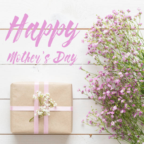 istock Mother's day background, white table with pink flowers and present 658226656