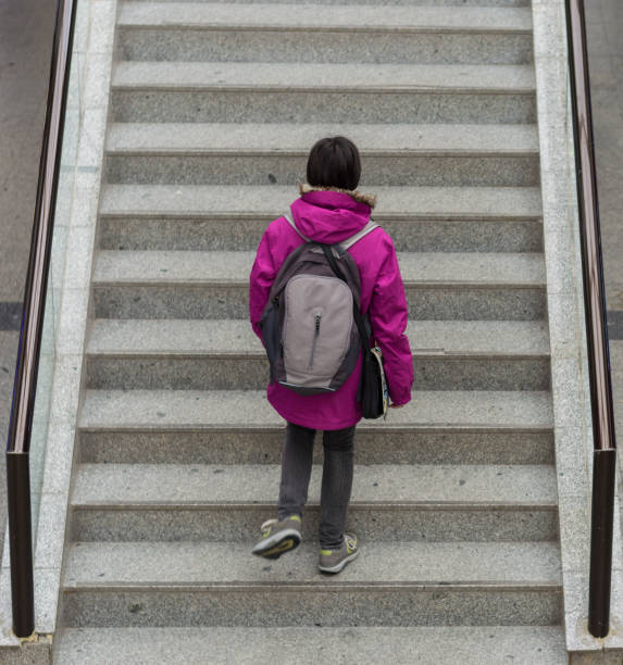 istock Young woman climbing the stairs 658230258