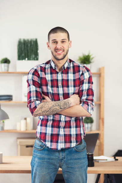 istock Man hands with tattoo working on laptop 658232998
