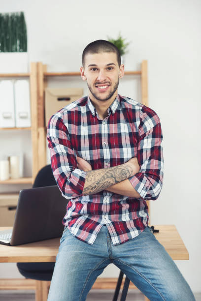 istock Man hands with tattoo working on laptop 658233018
