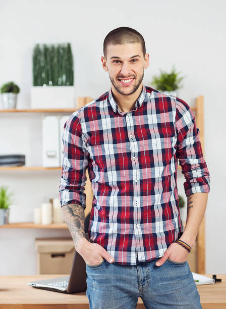 istock Man hands with tattoo working on laptop 658233554