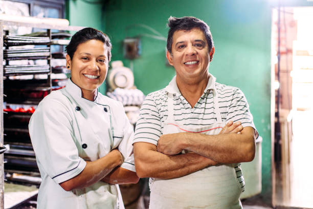 Artisan Bakery Father and daughter portrait in their small bakery in Mexico. baker occupation stock pictures, royalty-free photos & images