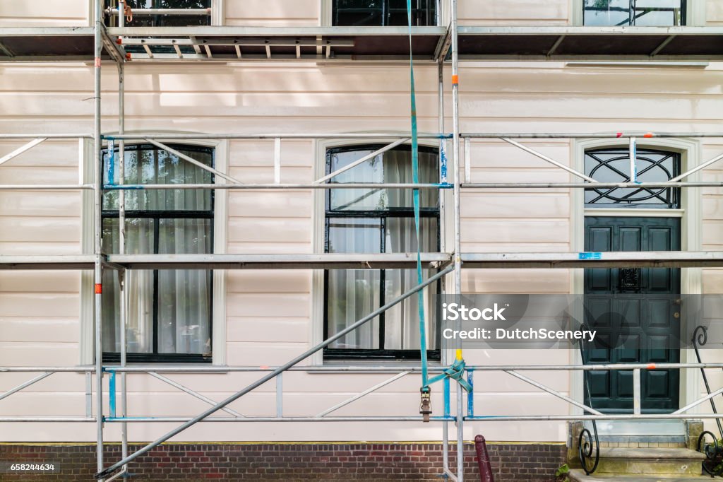Restoration and painting of an ancient Dutch wooden house Restoration and painting of an ancient Dutch wooden house in North Amsterdam Renovation Stock Photo